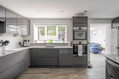 a kitchen with stainless steel appliances and a large window at Detached House in Quiet Village - Pets Allowed in Ipswich