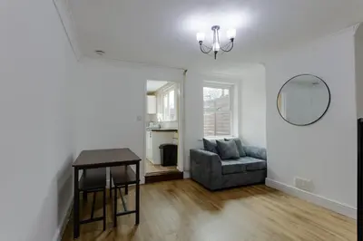 a living room with a table and a couch at ML Short Stays - 3 bed contractor house near Sizewell C in Leiston