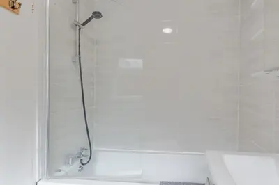 a shower with a glass door in a bathroom at ML Short Stays - 3 bed contractor house near Sizewell C in Leiston