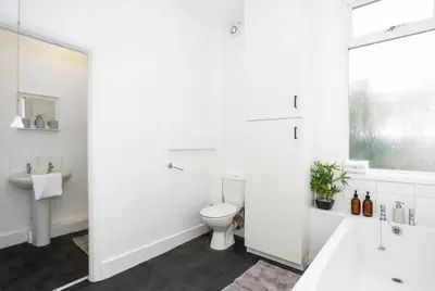 a white bathroom with a toilet and a sink at Modern 3 Bedroom Home with Parking in Southend in Southend-on-Sea