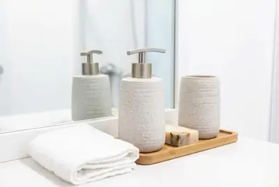 a bathroom counter with three towels and a mirror at Modern 3 Bedroom Home with Parking in Southend in Southend-on-Sea