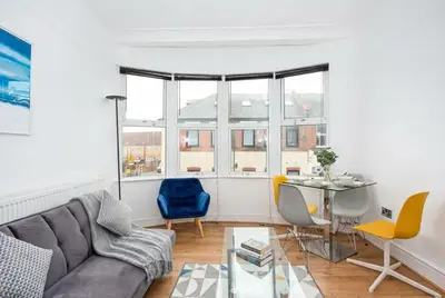a living room with a couch and a table at Modern 3 Bedroom Home with Parking in Southend in Southend-on-Sea