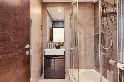 a bathroom with a shower and a sink at The Opulent Property Project Penthouse Chelmsford 2 Bed 2 Bath Sleeps 6 Free Parking 2 Kings or 4 singles and Double Sofabed Ideal for long stays, corporates, families, Insurance in Chelmsford