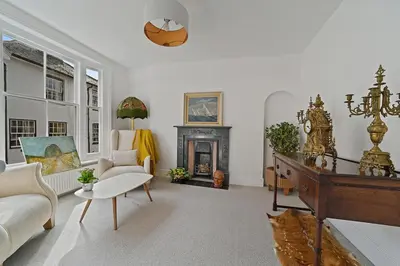 a living room with a couch and a fireplace at Beautiful Home at the Heart of Colchester Great for Commuters or Professionals in Colchester