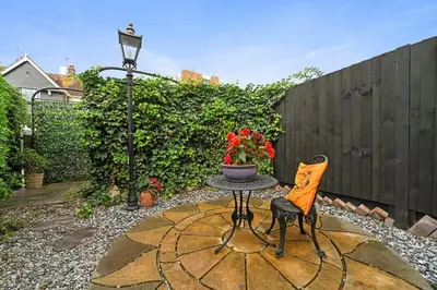 a small patio with a table and two chairs at Beautiful Home at the Heart of Colchester Great for Commuters or Professionals in Colchester