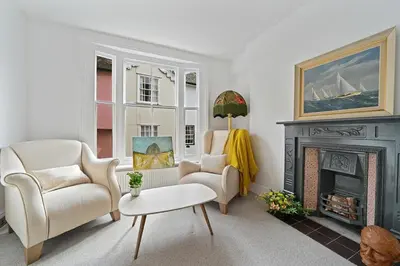 a living room with two chairs and a fireplace at Beautiful Home at the Heart of Colchester Great for Commuters or Professionals in Colchester