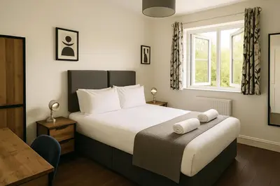 a bedroom with a bed with two towels on it at Free Parking-Modern Rooms in Central Cambridge Guest House by Luxiety Stays Near University in Cambridge