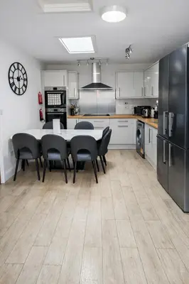 a kitchen and dining room with a table and chairs at Free Parking-Modern Rooms in Central Cambridge Guest House by Luxiety Stays Near University in Cambridge
