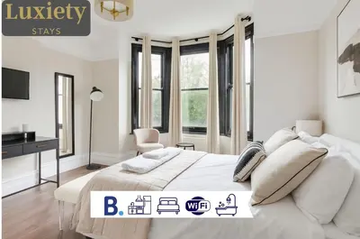 a white bedroom with a bed and a desk at Cambridge City Centre by Luxiety Stays Stylish Rooms, Prime Location & Wi-Fi in Cambridge