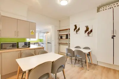 a kitchen and dining room with tables and chairs at Cambridge City Centre by Luxiety Stays Stylish Rooms, Prime Location & Wi-Fi in Cambridge