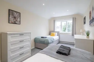 a bedroom with two beds and a dresser and a window at 4 BDR I sleeps 8 I Wi-FI I Free Parking I Central in Chesterton