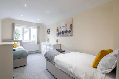 a bedroom with two beds and a window at 4 BDR I sleeps 8 I Wi-FI I Free Parking I Central in Chesterton