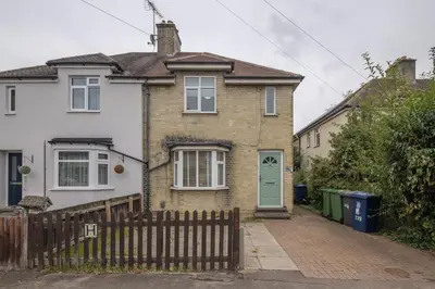 a brick house with a green door and a fence at 4 BDR I sleeps 8 I Wi-FI I Free Parking I Central in Chesterton