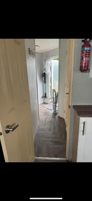 an open door to a room with a hallway at Seawick Staycay in Saint Osyth
