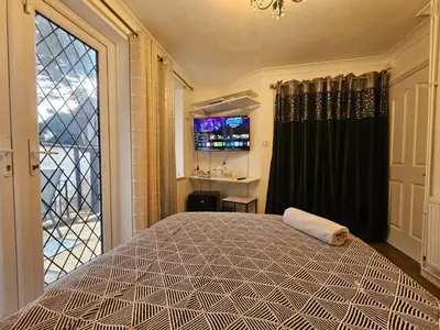 a bedroom with a large bed and a window at Meredith House, Ipswich in Ipswich