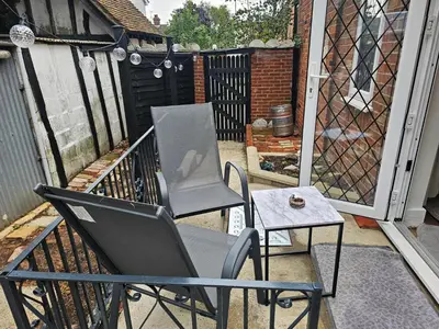 a chair and a table on a balcony at Meredith House, Ipswich in Ipswich