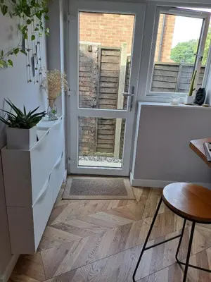 a room with a hallway with a door and a table at Whole Annexe in our family home & private entrance in Ipswich