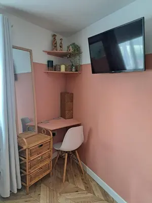 a bathroom with a vanity and a mirror and a tv at Whole Annexe in our family home & private entrance in Ipswich