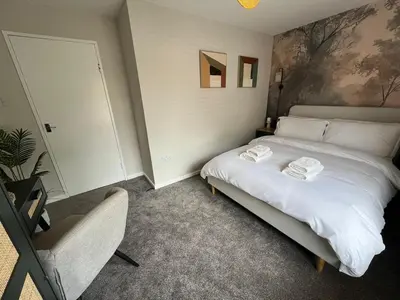 a bedroom with a bed with two towels on it at Stunning and Peaceful 2 bed Flat 10 mins from Stansted Airport in Stansted Mountfitchet