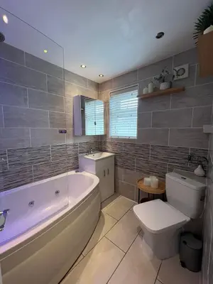 a bathroom with a tub and a toilet and a sink at Stunning and Peaceful 2 bed Flat 10 mins from Stansted Airport in Stansted Mountfitchet