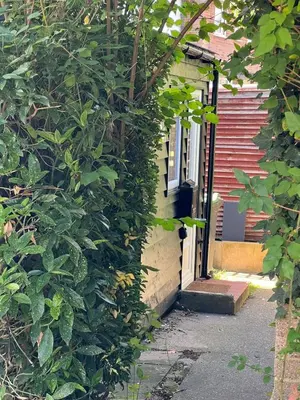 a door to a house with a ivy growing on it at Stunning and Peaceful 2 bed Flat 10 mins from Stansted Airport in Stansted Mountfitchet