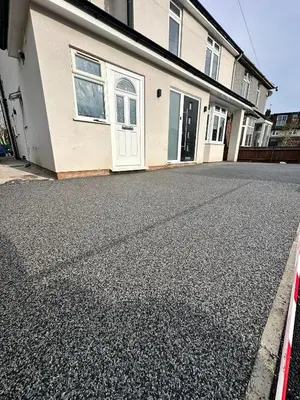 a house with a white door and a driveway at Abbey House in Waltham Abbey