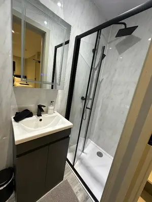 a bathroom with a sink and a shower at Abbey House in Waltham Abbey