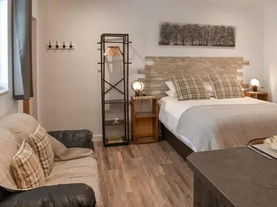 a bedroom with a bed and a chair and a couch at Saddlers - Uk50519 in Ovington