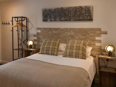 a bedroom with a bed and a brick wall at Saddlers - Uk50519 in Ovington