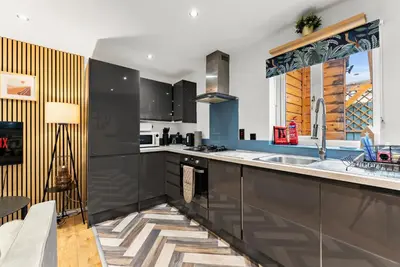 a kitchen with a sink and a counter top at Sleek & Stylish House in Cambridge - Sleeps 6 in Milton