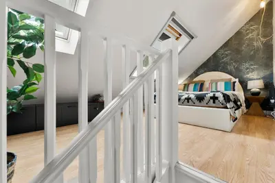 a white staircase with a bed in a bedroom at Sleek & Stylish House in Cambridge - Sleeps 6 in Milton