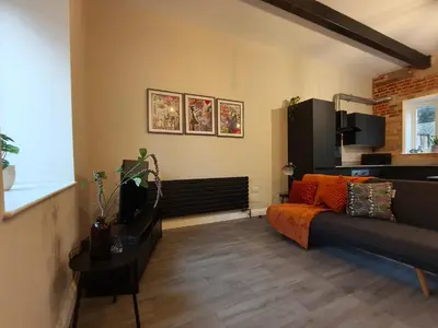 a living room with a couch and a table at Stylish 2-Bed Home Near A11 in Thetford