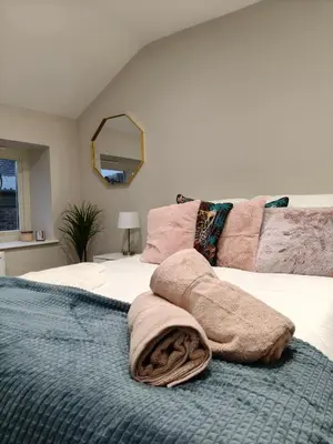 a bedroom with a bed with a blanket on it at Stylish 2-Bed Home Near A11 in Thetford