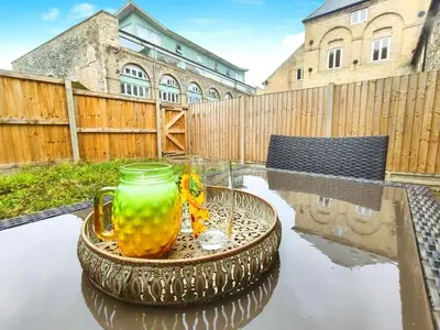 a glass vase sitting on top of a table at Stylish 2-Bed Home Near A11 in Thetford