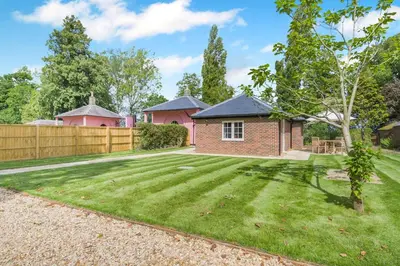 a garden with a brick house and a fence at 1 Bed in Wymondham oc-e32664 in Wymondham