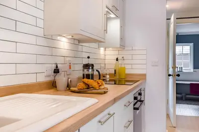 a kitchen with white walls and a counter top with food at 1 Bed in Wymondham oc-e32664 in Wymondham