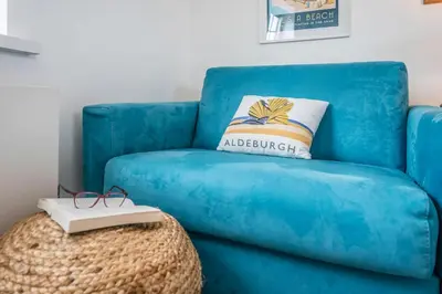 a blue couch with a pillow on top of a table at The Loft, Bungay in Bungay