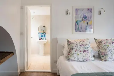 a bedroom with a bed and a mirror at The Loft, Bungay in Bungay