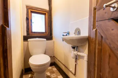 a bathroom with a toilet and a sink at Group Stays 600-Year-Old Barn, sleeps 11 in Great Parndon