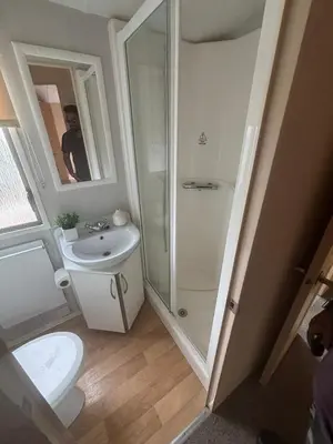 a bathroom with a shower and a toilet and a sink at Singh&Leite Family L6 in Saint Osyth
