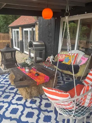 a porch with a hammock and a fire place at Goldings detached Barn farm stay in Hertford