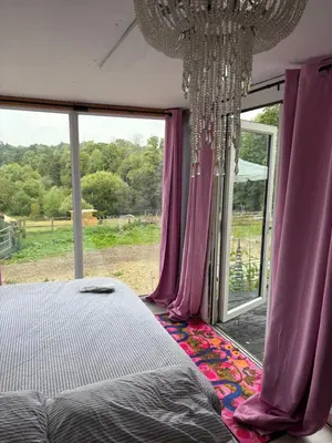 a bedroom with a bed and a large window at Goldings detached Barn farm stay in Hertford