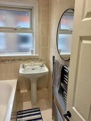 a bathroom with a sink and a mirror at Southend city Escape, SS1, High St and beach are steps away in Southend-on-Sea