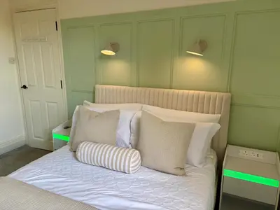 a bedroom with a bed with pillows on it at Southend city Escape, SS1, High St and beach are steps away in Southend-on-Sea