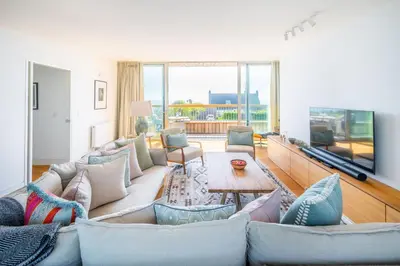 a living room with a couch and a table at Heath House 6 in Thorpeness