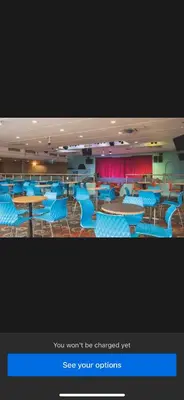 a room with blue chairs and tables and red curtains at The Orchards modern caravan in Saint Osyth