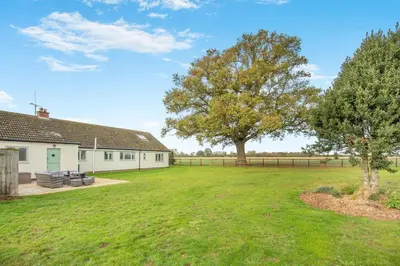 a large yard with a house and a tree at 5 Bed in Washbrook oc-m33105 in Hintlesham