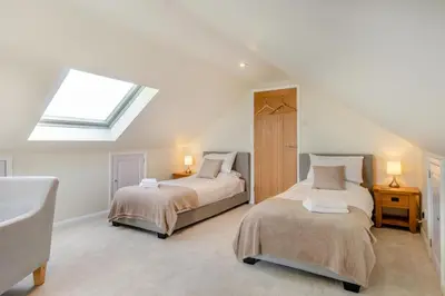 a attic bedroom with two beds and a skylight at 5 Bed in Washbrook oc-m33105 in Hintlesham