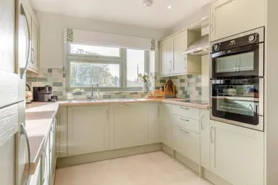 a kitchen with white cabinets and a window at 5 Bed in Washbrook oc-m33105 in Hintlesham