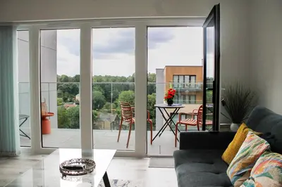 a living room with a view of a balcony at Stylish Essex Apartment, Balcony & Scenic Views in Harlow